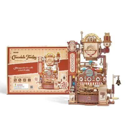 Detailed, colorful chocolate factory toy set with gears, conveyor belt, and candies, perfect for kids interested in imaginative play and learning about confectionery production.