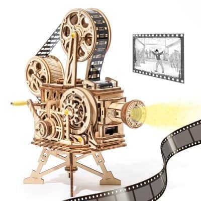 Optical film camera for cinema and filmmaking, with reels, lens, and film strip detail, suitable for movie production, cinematography, and vintage film equipment images.