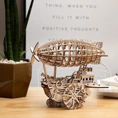 Intricate wooden airplane model with detailed gears and craftsmanship, perfect for aviation enthusiasts and decorative display.