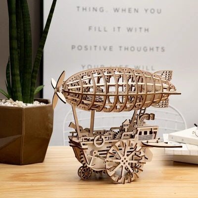 Intricate wooden airplane model with detailed gears and craftsmanship, perfect for aviation enthusiasts and decorative display.