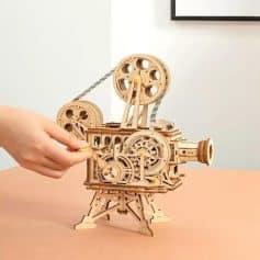 Optical toy camera made of intricate wooden parts, showcasing detailed gears and mechanical design for educational and decorative purposes.