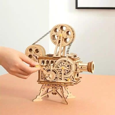 Optical toy camera made of intricate wooden parts, showcasing detailed gears and mechanical design for educational and decorative purposes.