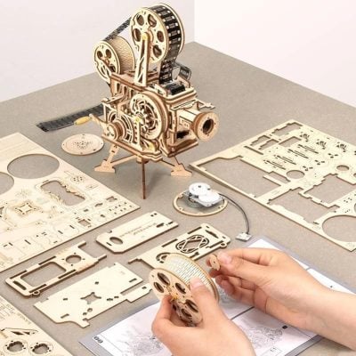 Exploring optical device assembly and mechanical engineering with precise wooden parts and gears. Ideal for DIY projects, educational kits, and optical instrument enthusiasts.