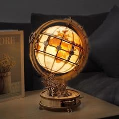 Illuminated globe lamp with world map design, decorative wooden base, perfect for modern home decor and travel enthusiasts. Adds a warm glow and stylish touch to any space.