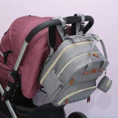 Child's school backpack, pink and gray color with multiple compartments and adjustable straps, perfect for elementary school children.