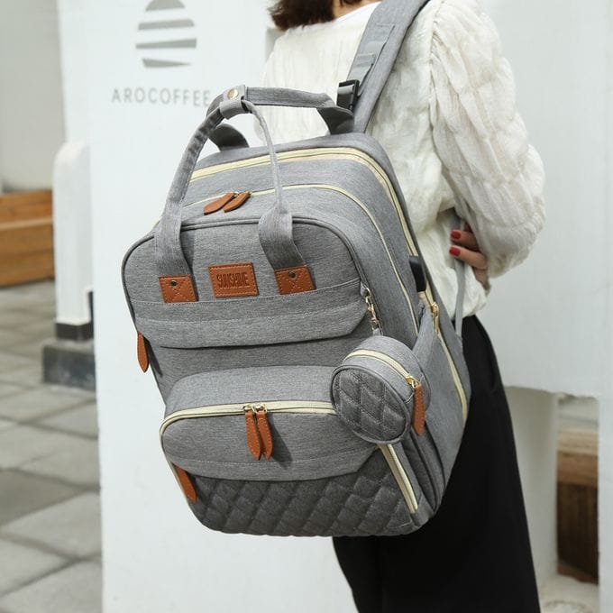 Comfortable grey travel backpack with multiple compartments and padded shoulder straps for daily commute and travel. Stylish and durable for convenient travel experiences.
