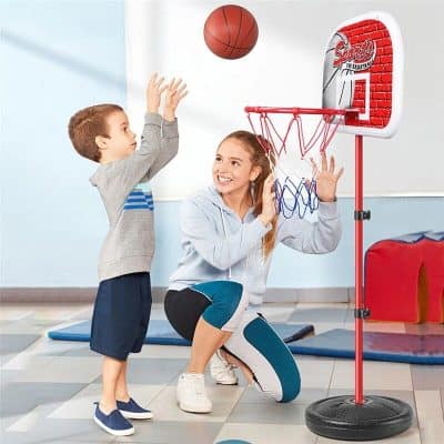Children enjoying indoor basketball game with mini hoop and ball for kids' active play at Monalisa Medical Store.