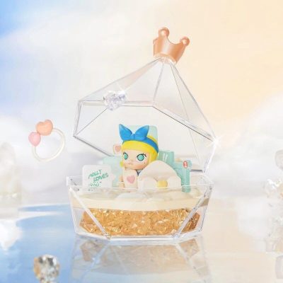 Miniature toy figure with blue bow inside clear gift box, perfect for kids and collectors looking for adorable presents.