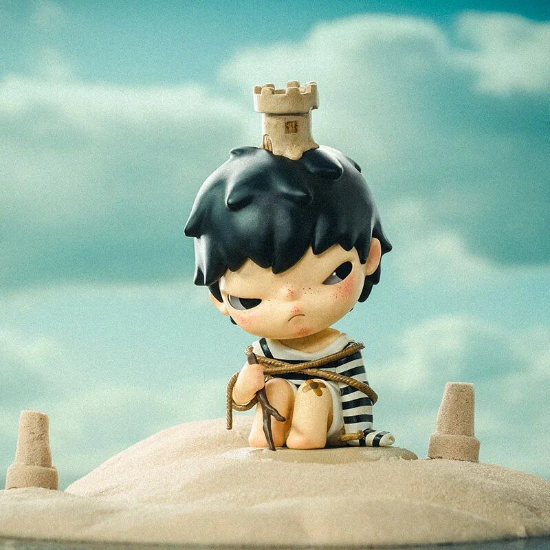 Cute collectible art toy featuring a character with a castle on its head, set against a sandy landscape, perfect for art toy enthusiasts and collectors.