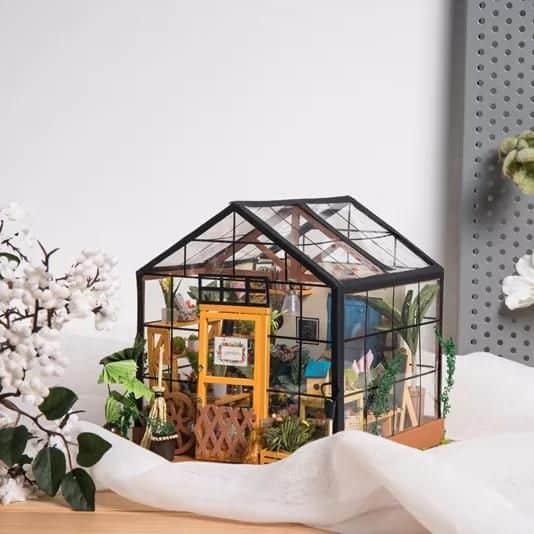 Detailed small greenhouse showcasing eyewear and accessory displays for optical stores and opticians.