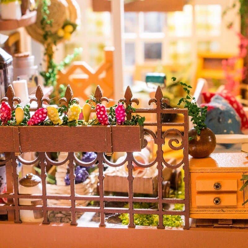 Decorative opt shop display with colorful flowers and cozy wooden accents for a welcoming optical retail environment.