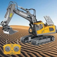 Robotic excavator in a sandy desert with remote control on ground.