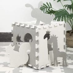 Bright white foam baby toy with animal cut-outs including a bunny, horse, and duck, designed for safe play and stacking.