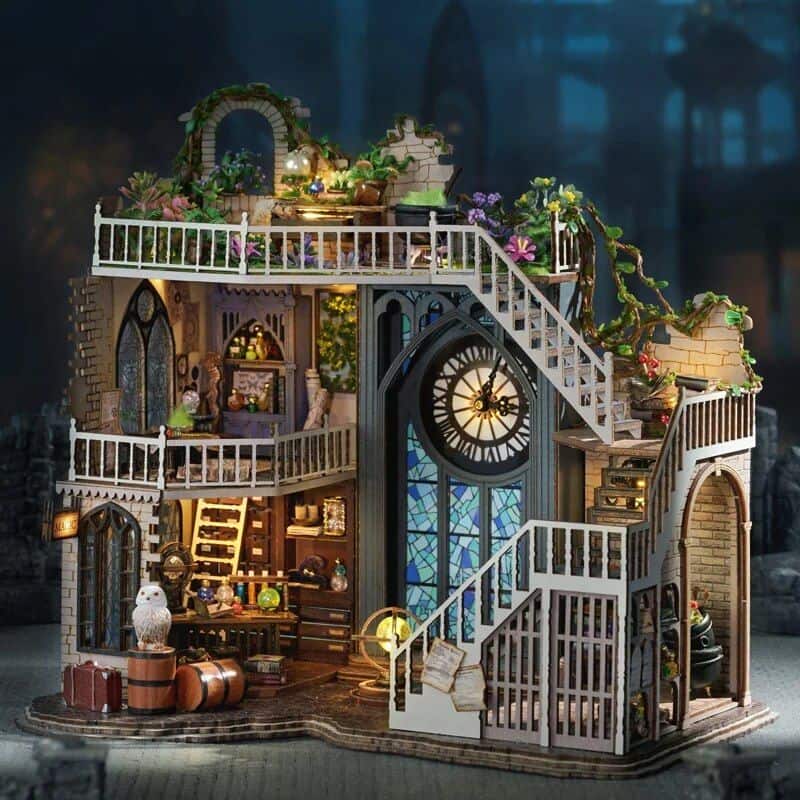 Detailed miniature dollhouse with clock tower, multiple floors, balconies, and whimsical decor, perfect for collectible enthusiasts and home decor lovers.