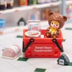 Adorable toy supermarket display with a bear-themed figure and colorful miniature products, perfect for kids' toy collection or playset.