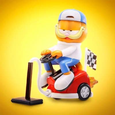 A playful monkey figurine riding a small race bike with a checkered flag, perfect for children's room decor or collection enthusiasts. Bright yellow background highlighting the whimsical design.