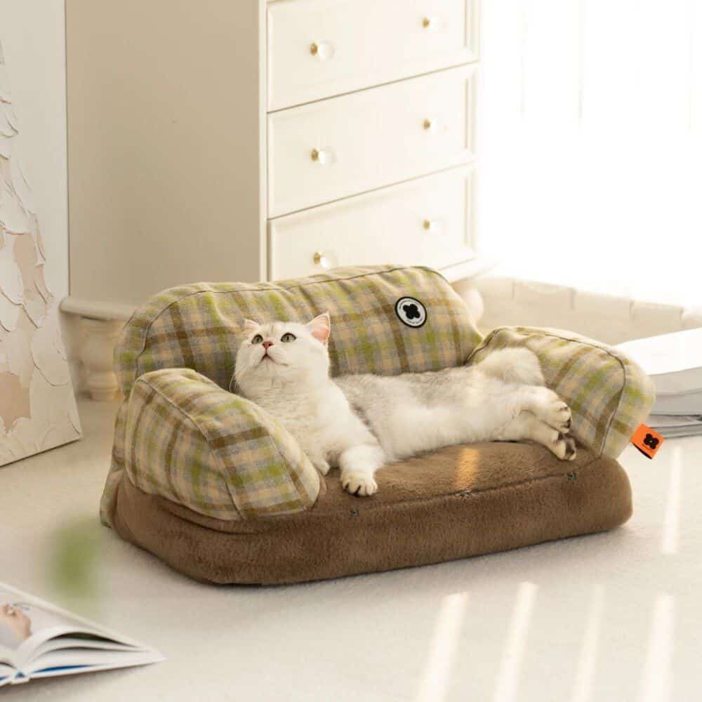 Soft, plaid cat bed with plush interior for comfortable lounging. Ideal for small cats or kittens, featuring durable fabric and cute design, perfect for pet owners seeking quality feline furniture.