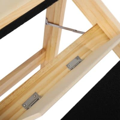 Close-up of a wooden optometry display frame with metal hinges, designed to hold glasses securely at Monalisa Medical.