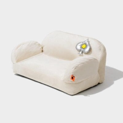 Comfortable beige sofa with playful balloon flower accent, perfect for modern home decor. Ideal for relaxation and stylish living spaces.