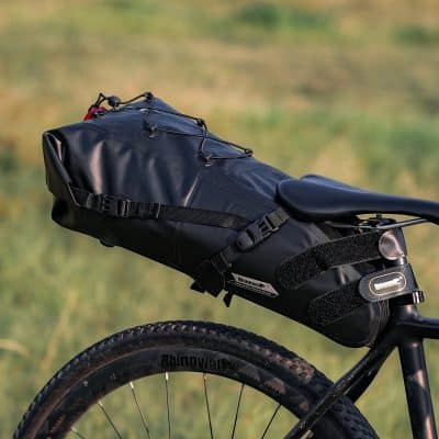 Durable black waterproof bike bag mounted on the saddle for convenient storage on cycling trips.