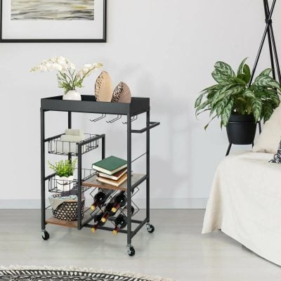 Stylish black metal and wood bar cart with wine rack, plant holder, and decorative trays, ideal for modern living rooms and entertainment spaces.