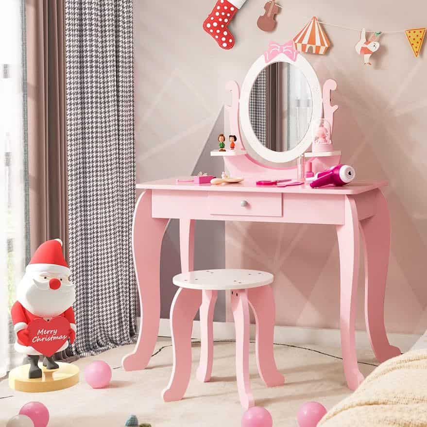 Cute pink vanity table for kids with mirror, storage drawer, and matching stool, perfect for children's beauty and playroom decor.