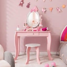 A pink children's vanity with a mirror and whimsical decorations, perfect for a kid's bedroom or playroom. Features a charming design with accessories like toys and beauty products, creating a delightful space for children to have fun and express themselves.