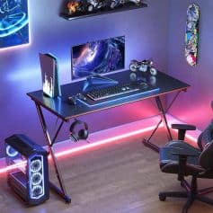 A high-tech gaming workspace with neon lighting, LED display, gaming chair, VR headset, and stylish decor, perfect for eSports and gaming enthusiasts.