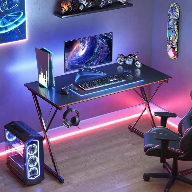 A high-tech gaming workspace with neon lighting, LED display, gaming chair, VR headset, and stylish decor, perfect for eSports and gaming enthusiasts.