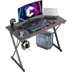 High-quality gaming desk with LED monitor, mechanical keyboard, gaming mouse, controllers, and gaming PC for immersive computer gaming and entertainment.