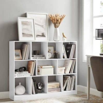 Stylish white bookshelf featuring decorative items, books, and modern accents in a bright, cozy home office or living room environment.