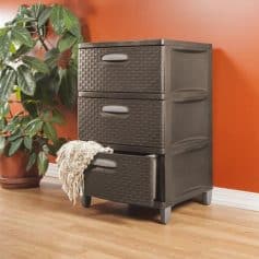 Stylish black storage cabinet with three drawers, ideal for bedroom or living room organization, featuring wicker-style fronts and a soft cloth hanging on the bottom drawer.