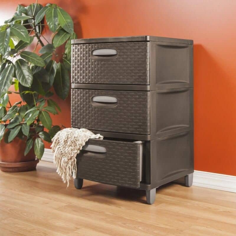 Stylish black storage cabinet with three drawers, ideal for bedroom or living room organization, featuring wicker-style fronts and a soft cloth hanging on the bottom drawer.