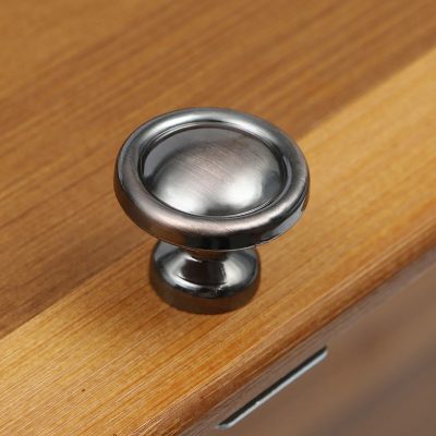Close-up of a stainless steel ear curette for safe ear cleaning, displayed on a wooden surface at Monalisa Store for medical and healthcare use.
