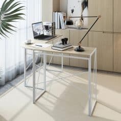 Light-colored wooden desk with minimalist design placed in a bright room, featuring a sleek laptop, books, and decorative items perfect for optical professionals or reading enthusiasts.