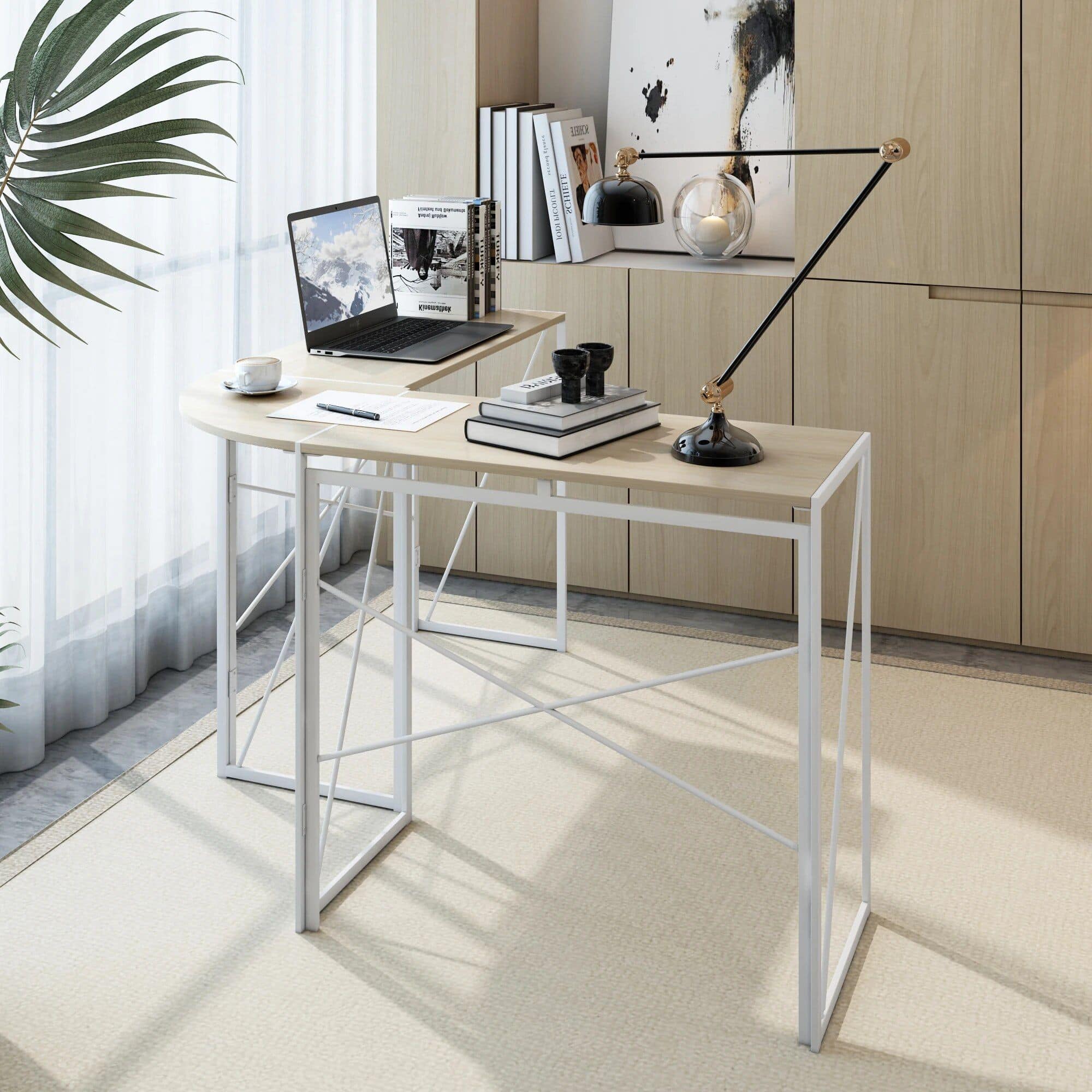 Light-colored wooden desk with minimalist design placed in a bright room, featuring a sleek laptop, books, and decorative items perfect for optical professionals or reading enthusiasts.