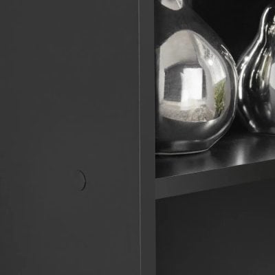 Close-up of luxurious, reflective, and elegant eyeglasses showcased on a black retail store shelf, emphasizing high-end optical products.