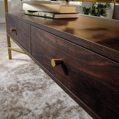 Stylish wooden TV console with gold knobs, perfect for contemporary home entertainment setup, blending functionality with elegant design.