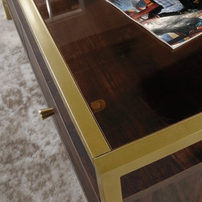 Contemporary wooden coffee table featuring a glossy finish, gold trim, and a glass top for stylish home decor.