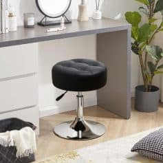 Stylish black salon stool with adjustable height and chrome base in a sleek, modern home or salon setting, ideal for professional or personal use, providing comfort and style.