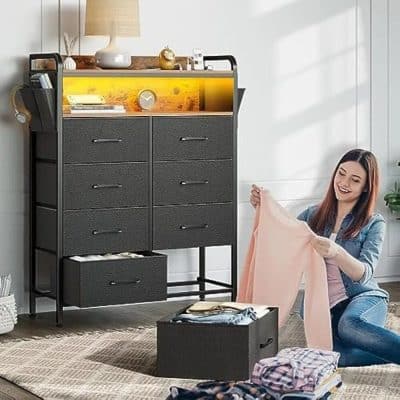 Stylish, modern black dresser with multiple drawers and compartments for organizing eyewear, glasses, and accessories. Perfect for opticians or eyewear stores to keep their glasses collection tidy.