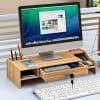 Stylish wooden computer desk with organized compartments, ideal for office work or study, featuring space for monitor, phone, stationery, and accessories for an efficient workspace.
