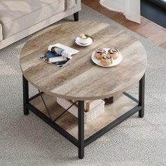 A stylish round wooden coffee table in a modern living room setting, decorated with magazines, coffee, and sweet treats for a comfortable and elegant atmosphere.