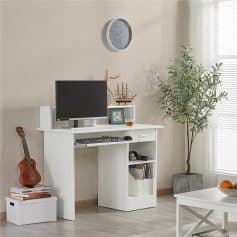 Comfortable workspace with sleek white desk, computer monitor, books, and decor in a bright living room.