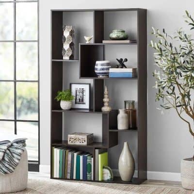 Stylish dark wood bookshelf with decorative vases, picture frame, and potted plant for elegant interior design.