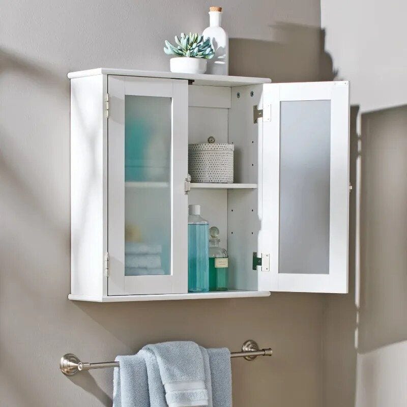 A white bathroom wall cabinet with frosted glass doors, storing toiletries, skincare, and decorative items, ideal for organizing your bathroom essentials efficiently.
