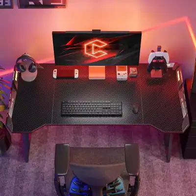 High-tech gaming desk with monitor, gaming controllers, keyboard, and headphones. Perfect for gamers seeking a sleek, modern workspace with optimal equipment for enhanced gaming experiences.