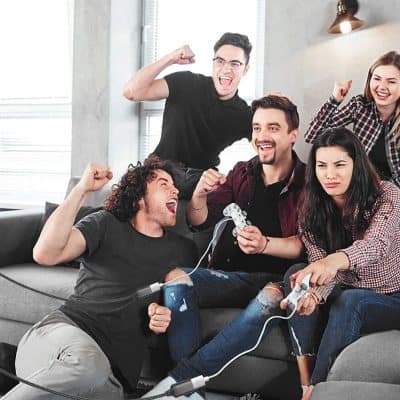 Vibrant scene of friends enjoying arcade gaming experience at Monalisa Store with energetic atmosphere and gaming excitement.