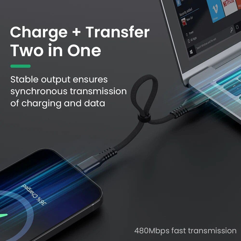 A close-up of a fast charging and data transfer cable connecting a smartphone to a laptop for efficient, synchronous charging and data transmission.