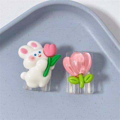 Colorful bunny and pink flower hair clips with green leaves, perfect accessories for hair decoration, stylish and adorable for all ages.